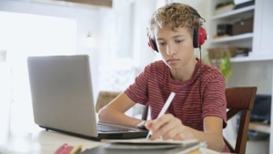 Picture of student learning remotely on laptop